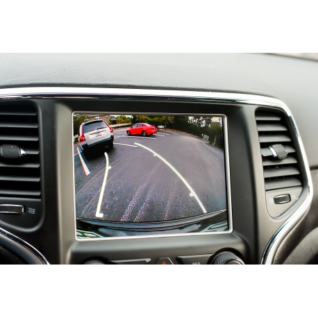 Factory dashboard screen displaying a live backup-camera view with dynamic parking guidelines